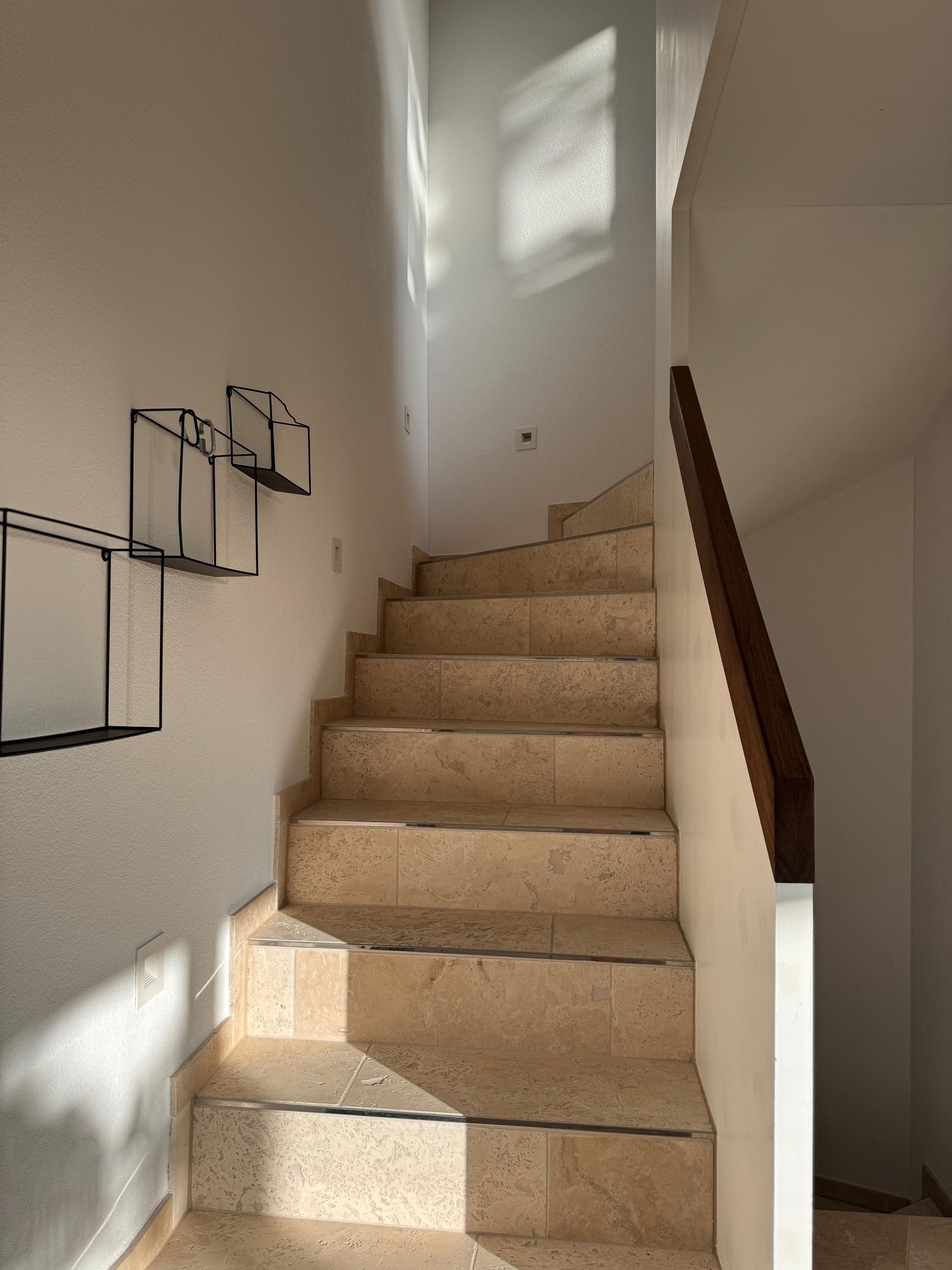 Travertine natural-stone staircase inside Villa 77