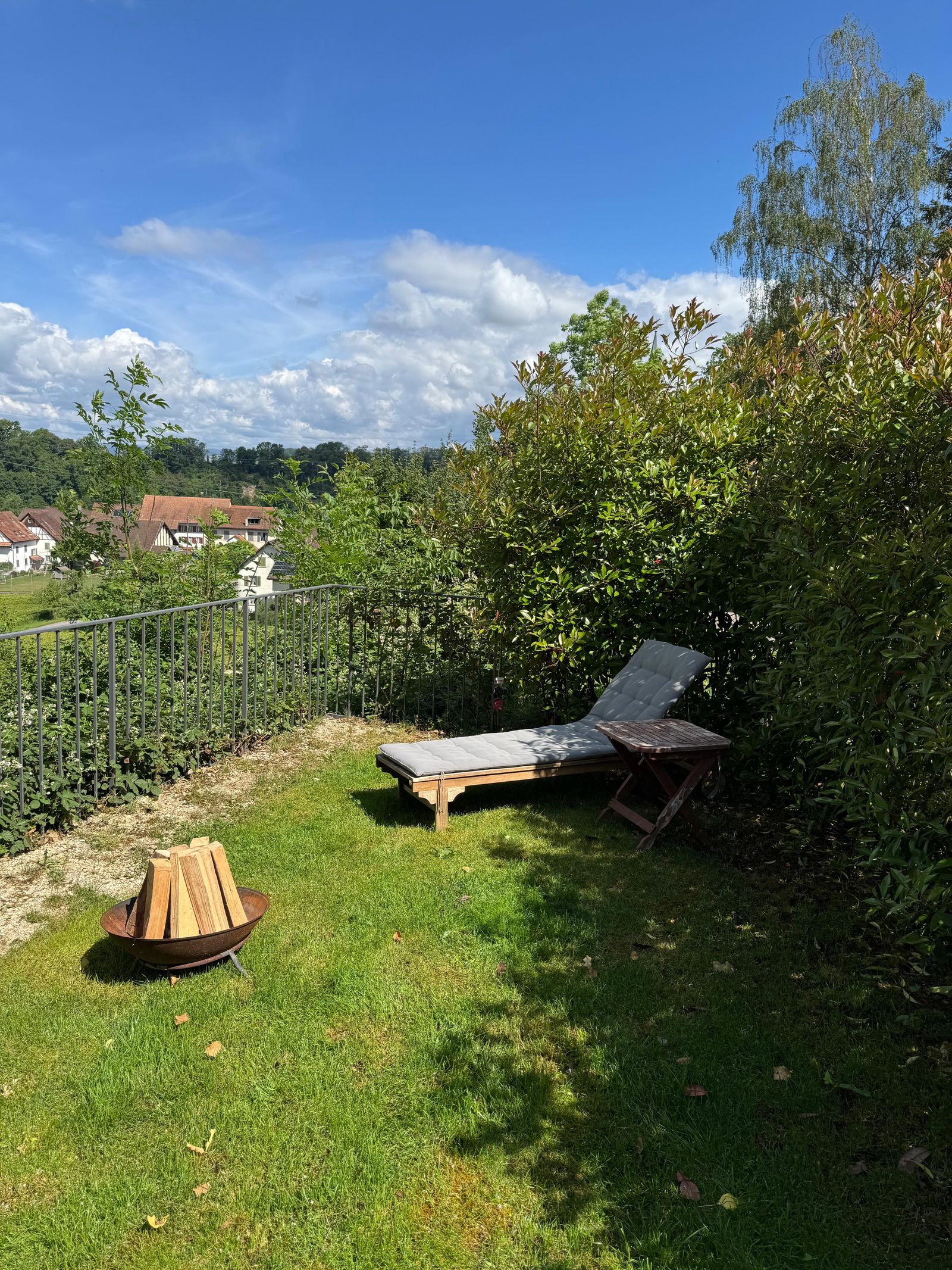 Garden of Villa 77 with a sun lounger and open views