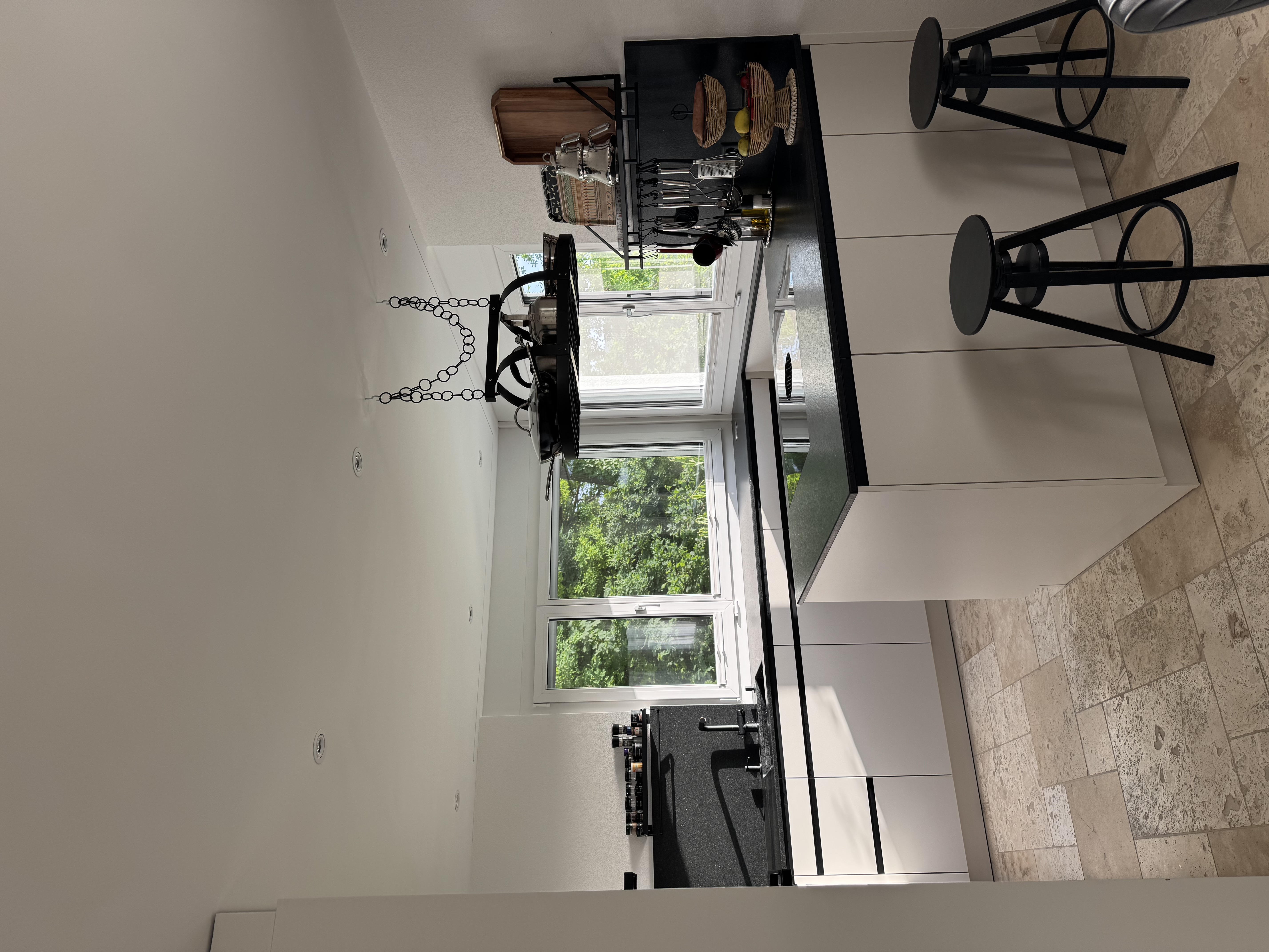 Designer kitchen with black worktop and induction cooktop at Villa 77, furnished house near Baden